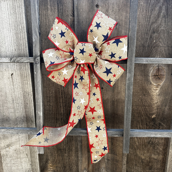 Decorative bow with red, white, and blue stars on a wooden background