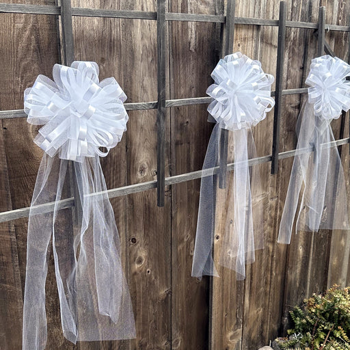 large white wedding pew tulle bows