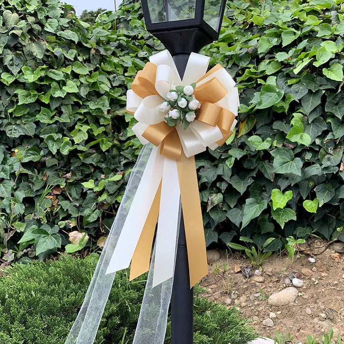 gold-and-ivory-wedding-bows-with-tulle-tails-and-rosebuds